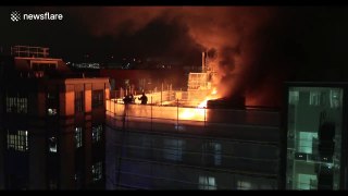 Firefighters tackle blaze on roof of London building