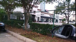 Lady poops in front of Italian Restaurant