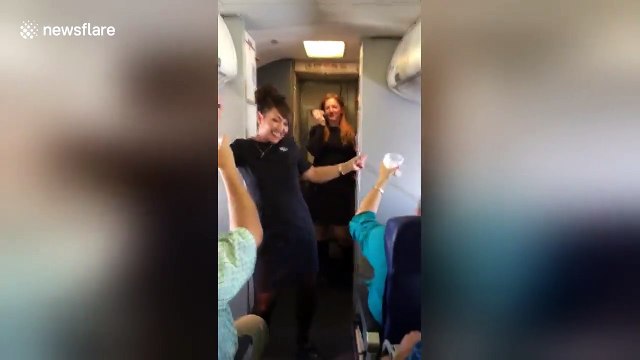 Flight attendants dance and sing during Southwest airlines flight