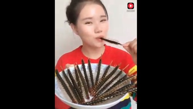 Chinese girl eating the different types of insects