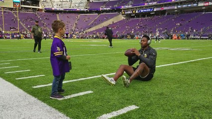 Stefon Diggs plays catch with young fan wearing his jersey