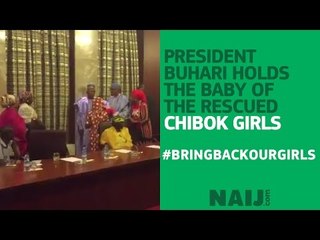 President Buhari holds the baby of the rescued Chibok girl