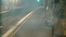 Dramatic footage shows woman pulled away from oncoming train with seconds to spare