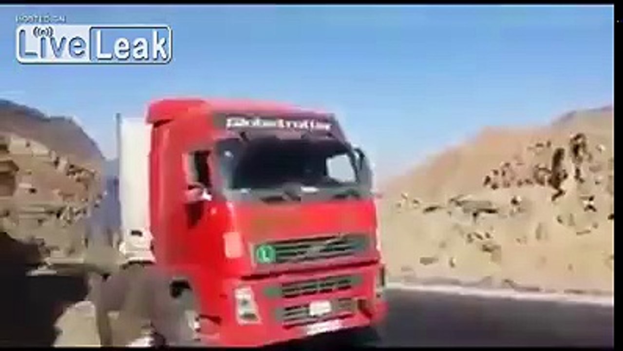 pick up truck pulls loaded semi up the mountain.