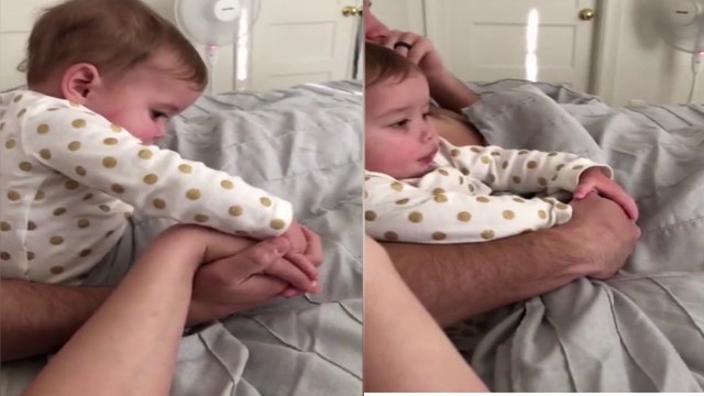 Hilarious moment a baby refuses to share her dad with her mum