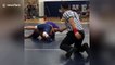 Wrestling referee makes CRAZY slide across mat