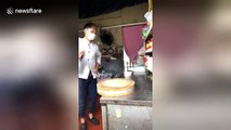 Young chef shows off meat cleaver spinning techniques