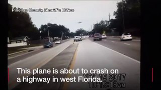 Police dashcam footage shows the moment a plane crashes into a highway in Florida