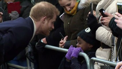 Prince Harry helps straighten child's hat