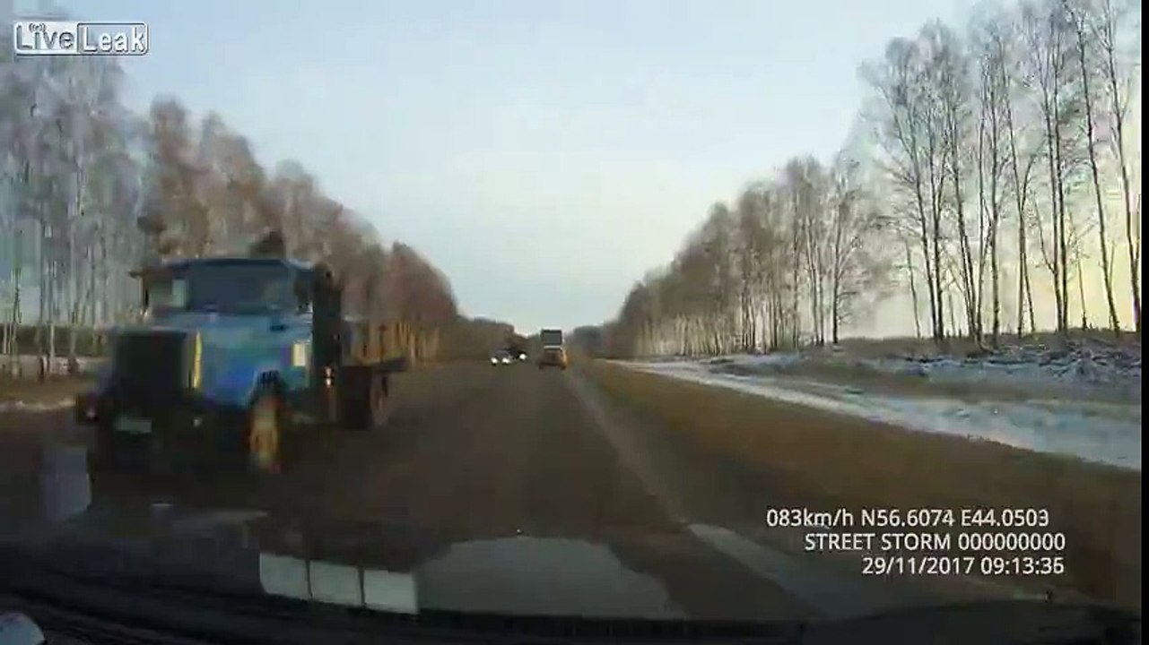 Flying debris off a truck hits a car's windshield