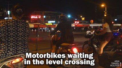Motorbikes waiting in the level crossing Hua Hin