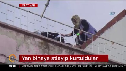 Yan binaya atlayıp kurtuldular