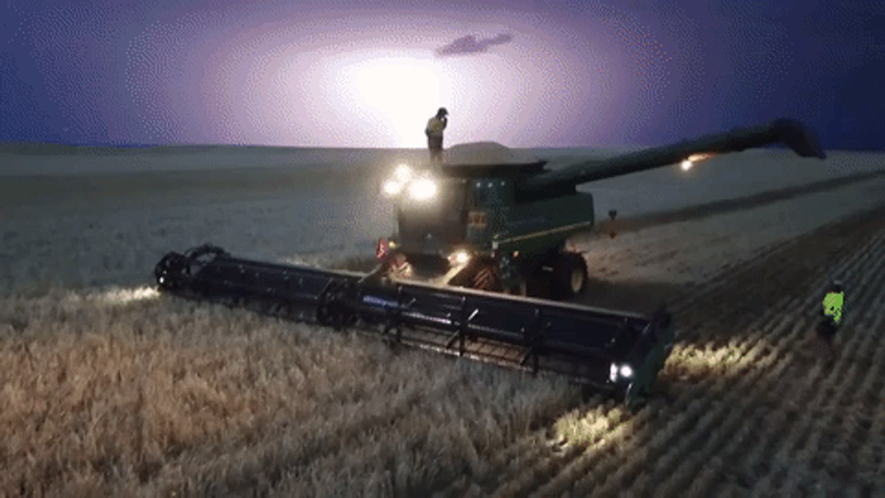 Aerial Footage Shows Man Dancing on Top of a Harvester During a Lightning Storm