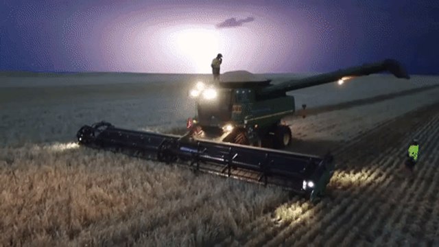 Aerial Footage Shows Man Dancing on Top of a Harvester During a Lightning Storm