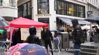 Activists in Switzerland hold a mock slave auction in busy public square