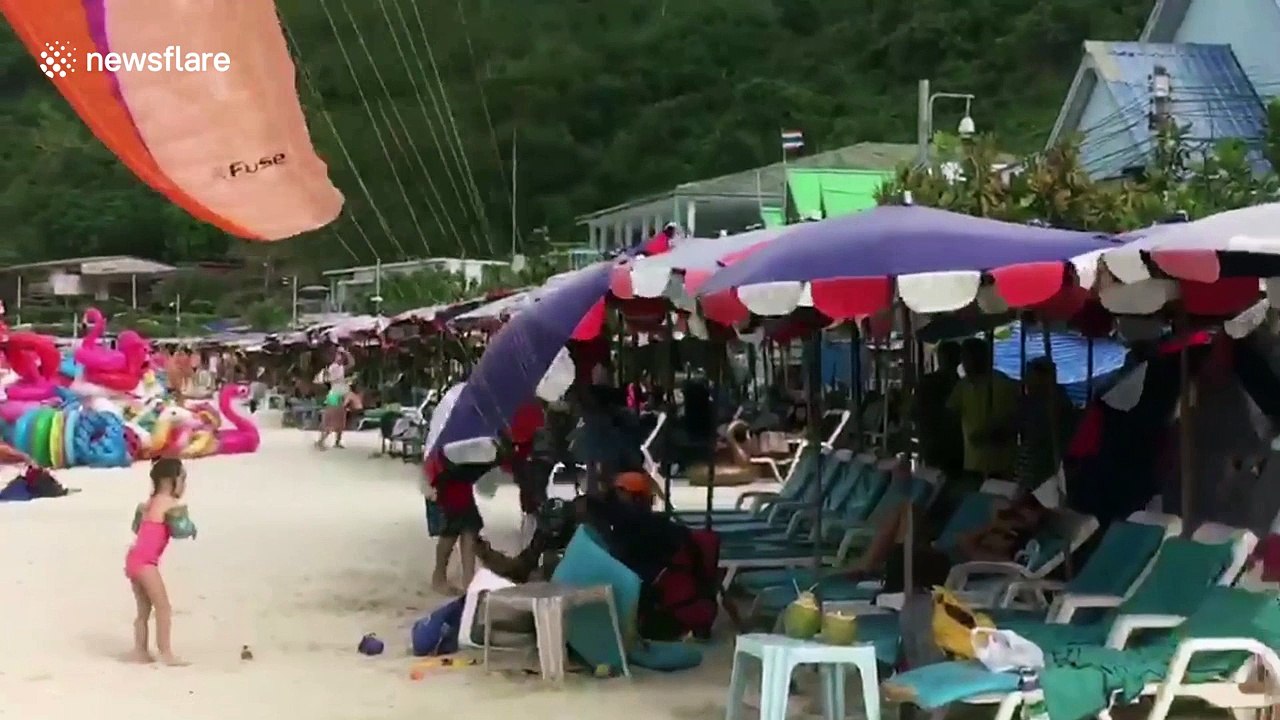 Paragliding tourist crashes into sunbathers on Thai beach