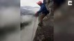 Long way down! Adrenaline junkie makes stomachs churn with back-flip off cliff