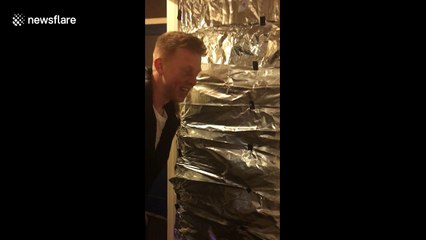 Men cover friend's door with tin foil for birthday