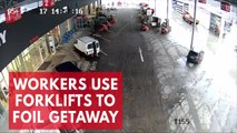 Warehouse workers use forklifts to block suspected thieves from leaving