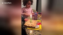 Boy struggles to blow out birthday cake candle