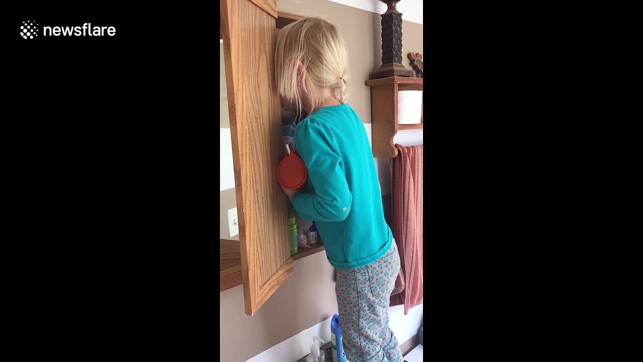 Girl hides her face after using her mother's make up