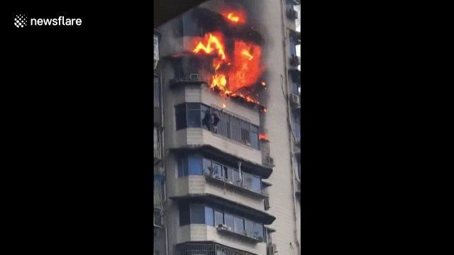 Man hangs out 23rd floor window after escaping from ablaze flat