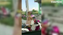 Dog In Women's Clothes Sitting On Motorbike