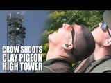 Crow shoots the clay pigeon high tower