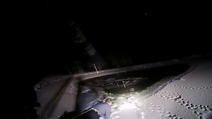 Police officer crawls across ice to rescue trapped dog