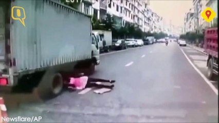 Download Video: Elle passe à 2 doigts de se faire ecraser la tête par un camion... Chaud