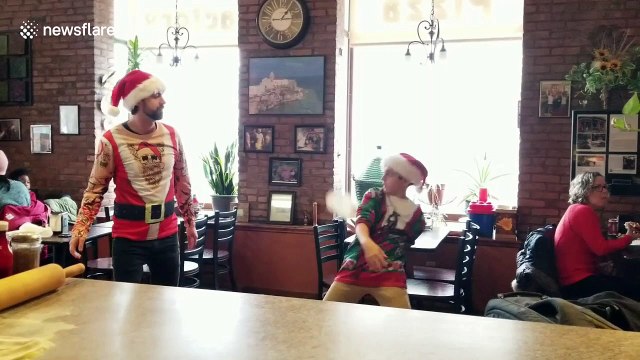 Watch this boy toss pizza dough like a pro (even his Santa hat gets involved)