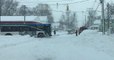 Tow Truck Pulls Erie Bus Through Snowy Street