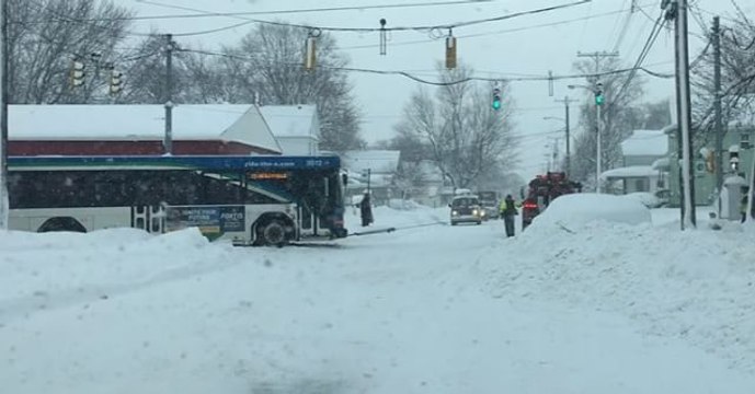 Tow Truck Pulls Erie Bus Through Snowy Street