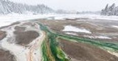 Kaleidoscope of Colors Flows Through Frozen Yellowstone Landscape