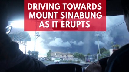 Mount Sinabung's massive eruption seen from vehicle approaching the spewing spectacle