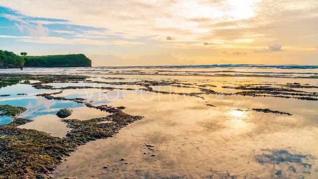 Clouds Reflecting in the Water on the Beach Balangan the Island of Bali in Indonesia by Timelapse4K