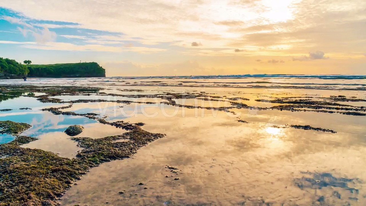 Clouds Reflecting in the Water on the Beach Balangan the Island of Bali in Indonesia by Timelapse4K