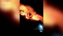 Students film hillside blaze next to university dorms