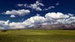 Clouds Over the Mountains and Green Field of Wheat in Kazakhstan by Timelapse4K