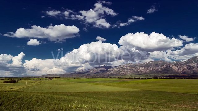Clouds Over the Mountains and Green Field of Wheat in Kazakhstan by Timelapse4K