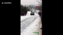 SUV slides dangerously down snow-covered road in China