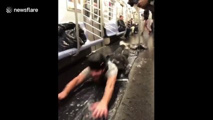 Pranksters use New York subway car to 'slip and slide'