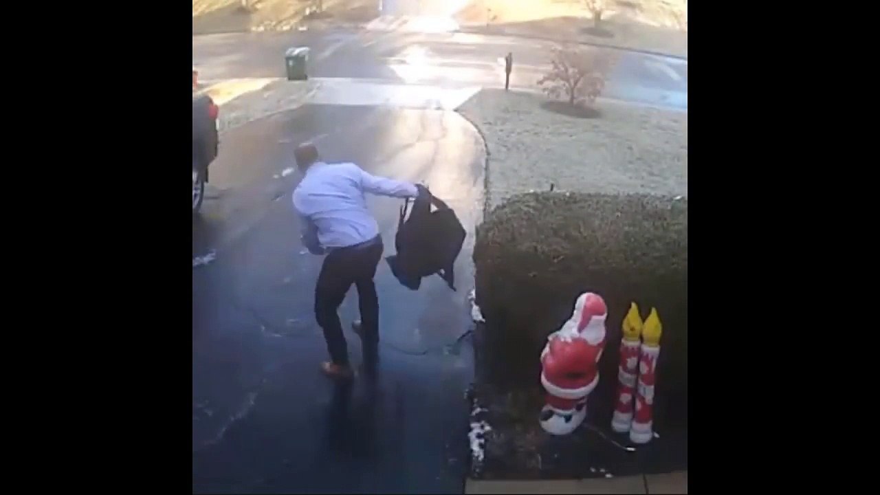 Man slip and slide down skating along black ice in suit and shoes.