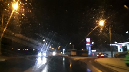 Snowing night drive trip into the car