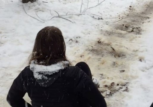 Woman Uses Makeshift Sled to Enjoy Snow Day in Chapel Hill