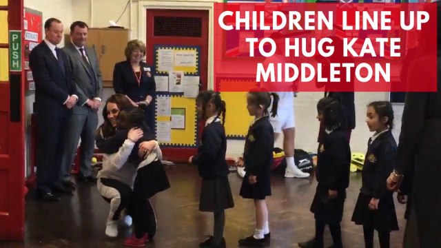 Children line up to hug Kate Middleton