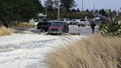 Storm Surge Leaves Car Stranded on Sand Dune
