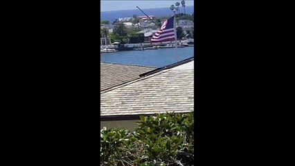 Silver Shiney UFO HOOVER over the water on Harbor