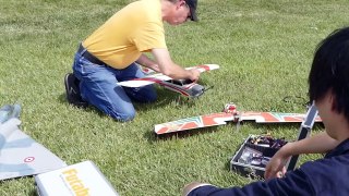 Dad teaches Jun how to fly a model plane