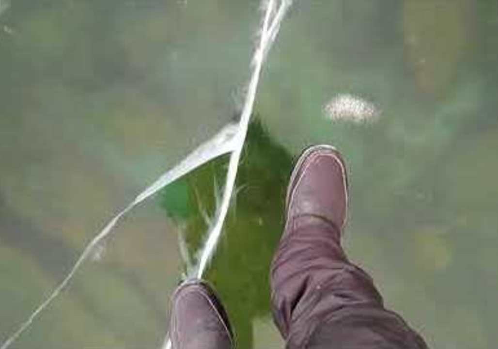 Man Films Thrilling Walk on Frozen Lake